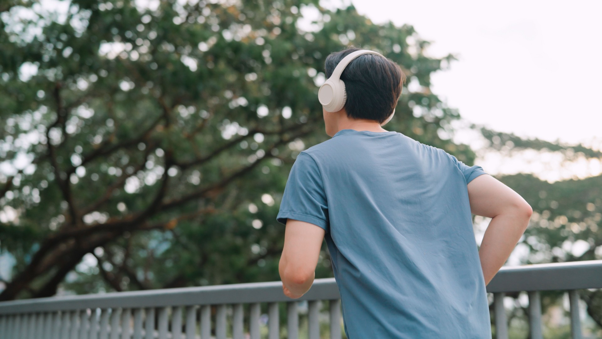 Asian young man running in public park